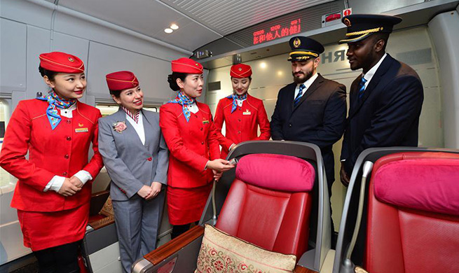 Foreign volunteers serve passengers during Spring Festival travel rush in China's Xi'an