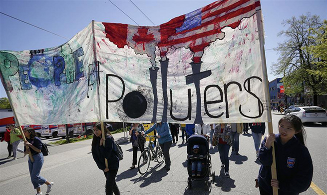 People take part in Earth Day parade in Vancouver